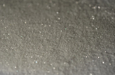 Blurred background with glitter sparkles like a snow in the night lights