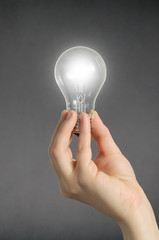 Hand with light bulb