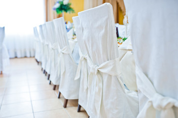 Fototapeta na wymiar White wedding chairs on restaurant