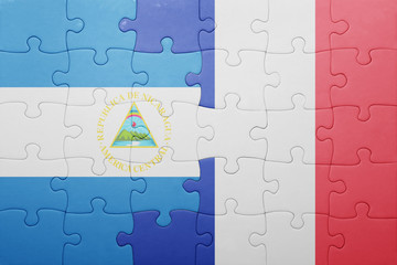 puzzle with the national flag of nicaragua and france