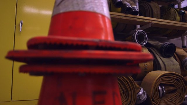 An assortment of Fire hoses rolled up on a shelf in a fire station. Dolly Shot