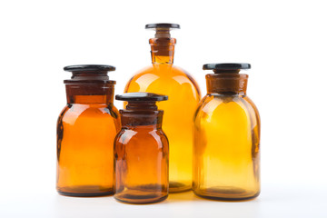 Vintage pharmacy bottles on white background