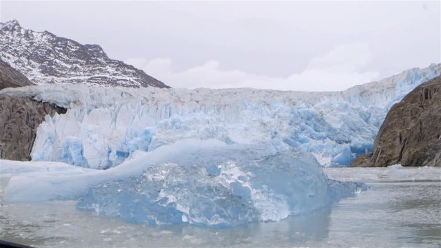Glacier in Greenland with mountains in the background. Slow Motion