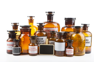 Vintage pharmacy bottles on white background
