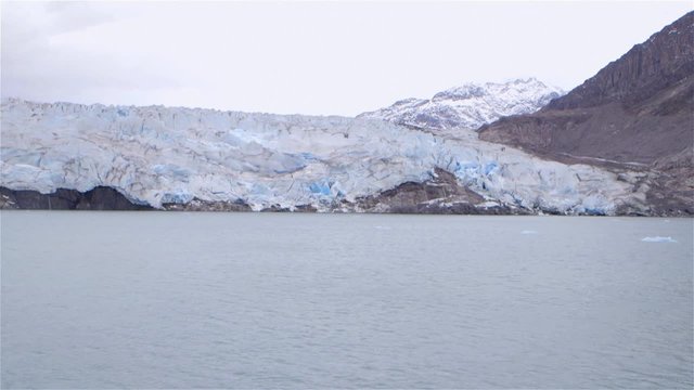 Slow motion shot of a glacier in Greenland. Pan Left