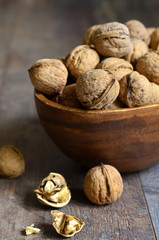 Walnuts in a wooden bowl .