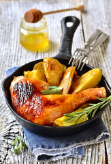 Roasted chicken leg with potato.