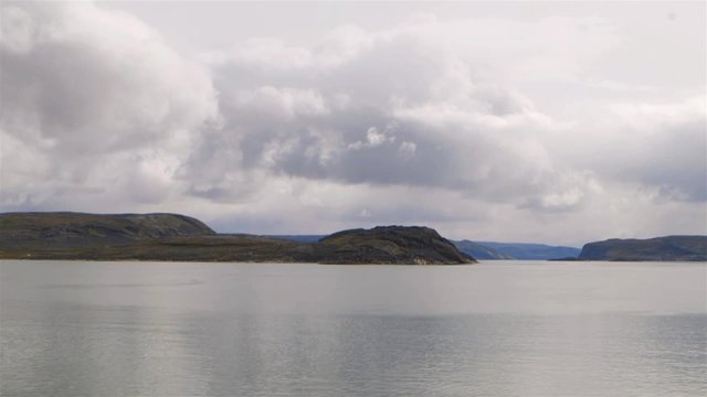 Mountain ranges stretch across a shoreline. Slow Motion
