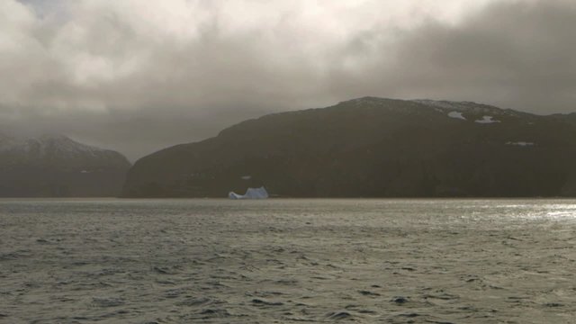 Iceberg in front of a Labrador coastal landscape. Slow Motion
