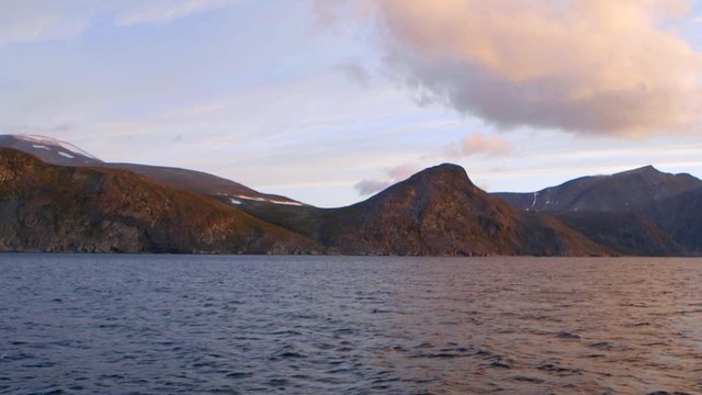 Traveling shot Northern Labrador coastal landscape with mountains in background. Slow Motion