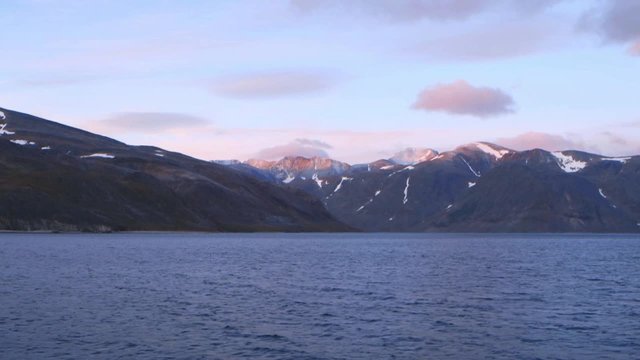 Traveling shot Northern Labrador coastal landscape with mountains in background. Slow Motion