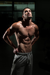Fototapeta na wymiar Strong Bodybuilding Man Looking Up