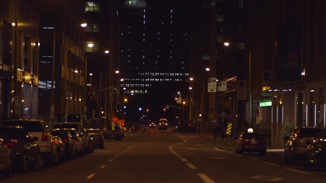 POV looking down a street in downtown Ottawa, Ontario at night.