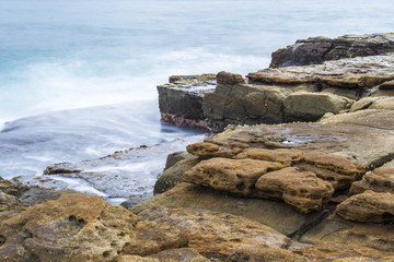 Rocks and waves at Point Cartwright beach in the afternoon. Sunshine Coast, Queensland.