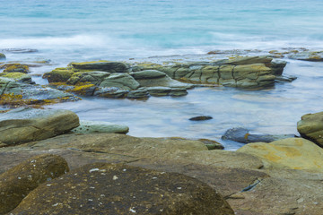 Rocks and waves at Point Cartwright beach in the afternoon. Sunshine Coast, Queensland.