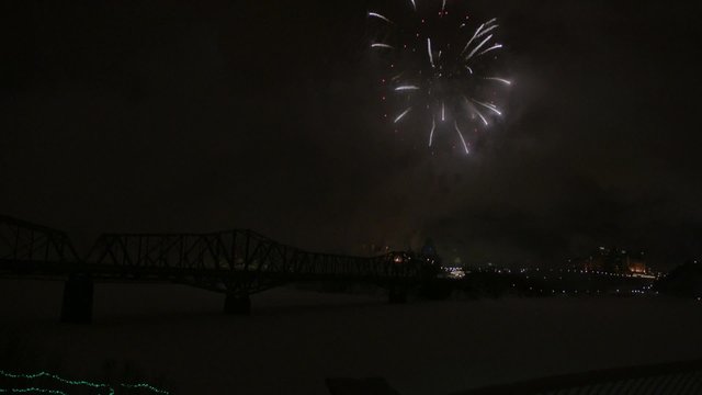 Slow motion fireworks over Alexandria Bridge crossing the Ottawa River during Winterlude.