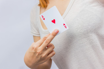 young woman holding in hand poker card with combination of Full