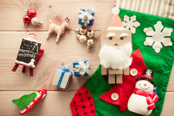 Toys and Christmas decorations placed on wood.