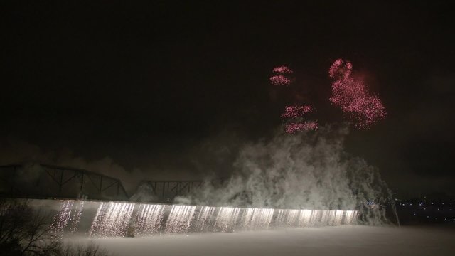 Slow motion fireworks over Alexandria Bridge crossing the Ottawa River during Winterlude.