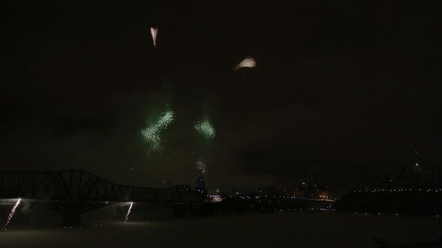 Slow motion fireworks over Alexandria Bridge crossing the Ottawa River during Winterlude.