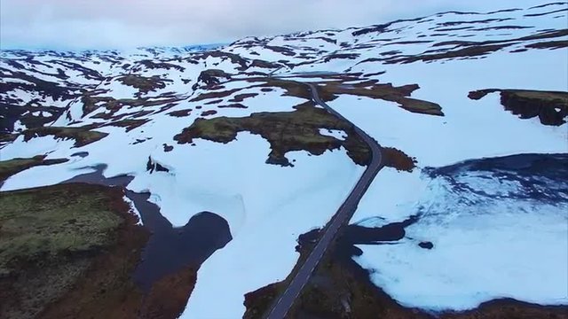 Aerial view of Aurlandsfjellet mountain pass, popular tourist route in Norway, on cold cloudy summer evening. Aerial 4k Ultra HD.