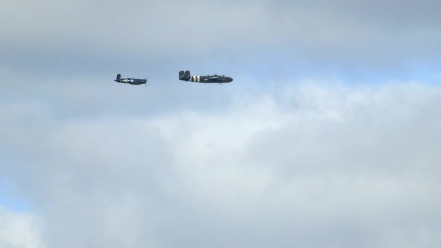 A North American B-25 Mitchell Plane and a Goodyear FG-1D Corsair fly over Ottawa, Ontario.