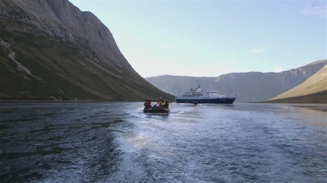 Tourists on a zodiac boat tour through Torngat Mountains during an expedition. Slow Motion