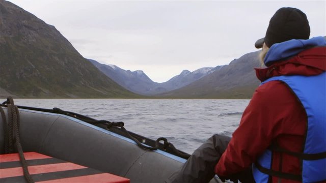 Tourists on a zodiac boat tour through Torngat Mountains on expedition. Slow Motion