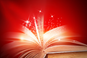 Opened magic book on abstract red gold background 