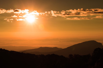 Beautiful sunset at the mountains. Colorful landscape with sun and