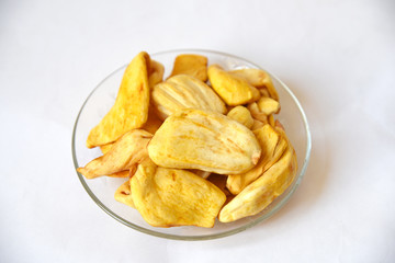 fried jackfruit chips in glass dish on white background