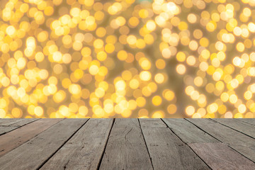 Naklejka na ściany i meble wood table in front of golden bright bokeh lights