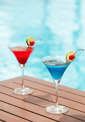 cocktail glass on wood table at pool