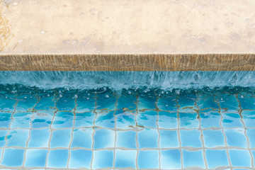  a water feature and flagstone is shown on a suburban pool