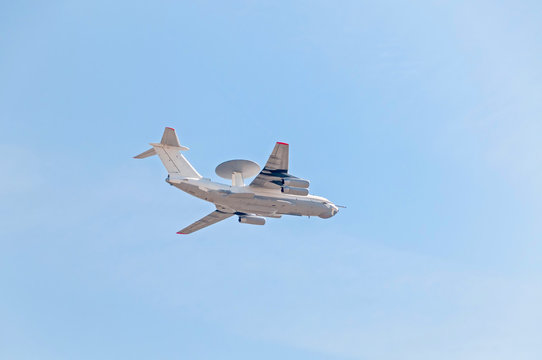 Beriev A-50 (Mainsta) Russian airborne warning and control system (AWACS) aircraft flies against blue sky background.
