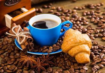 Coffee cup and coffee beans on table