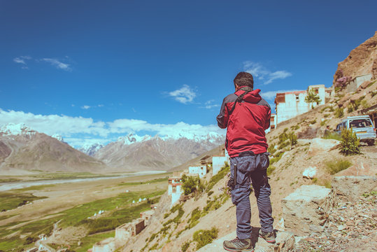 Back of photographer taking photo at Karsha Monastery, Padum, In