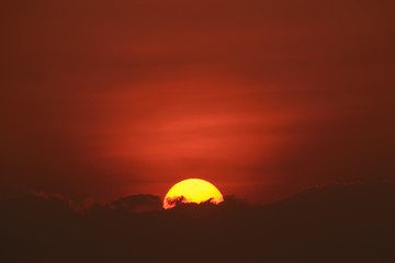 Fototapeta na wymiar Rising sun with cloud