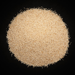 Top view of Organic White Poppy seeds (Papaver somniferum) isolated on dark background. © Prashant ZI