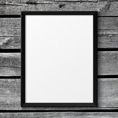 Blank black picture poster frame on the white wooden texture