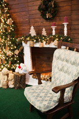Christmas holiday background of wooden chair against decorated C