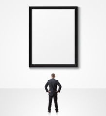 businessman looking up at empty poster