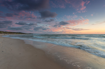 Baltic sea coast at picturesque sunset in Rowy, near Ustka, Poland