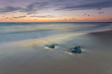 Baltic sea coast at picturesque sunset in Rowy, near Ustka, Poland
