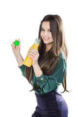 Teenage girl happy while holding a bottle of orange juice.in a green blouse. isolated on a white background