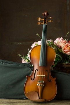 vintage violin resting against an old steel background
