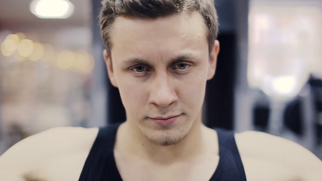 Man in gym on machine exercising close-up  slow motion