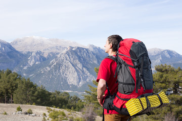 Hikers with backpacks enjoying valley view from top of a mountain