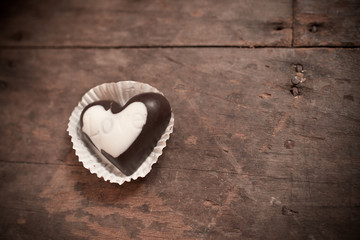 Naklejka na ściany i meble Chocolate heart on wooden background