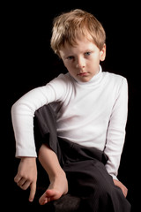 Portrait of the boy on a black background.